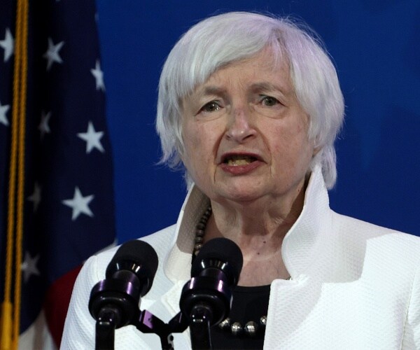 janet yellen speaks into microphone