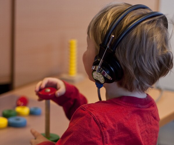 a young boy taking a hearing test