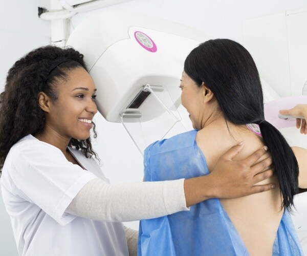 woman undergoing mammogram