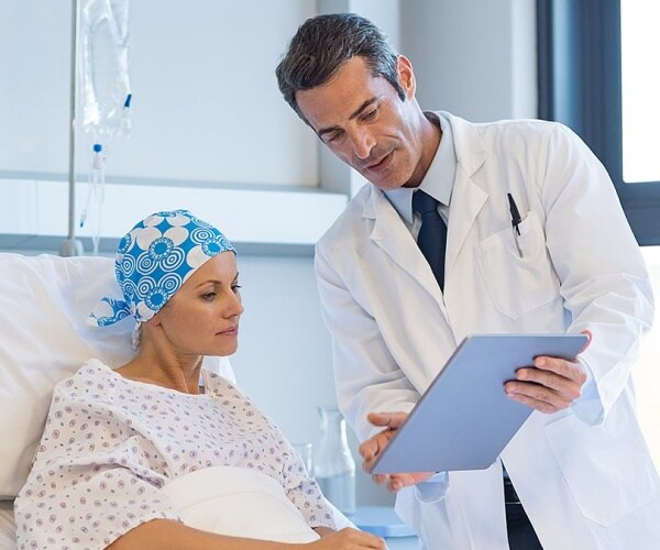 doctor talking to a woman with breast cancer about her treatment