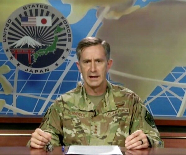 schneider in a camouflage uniform speaking from a us air base in japan