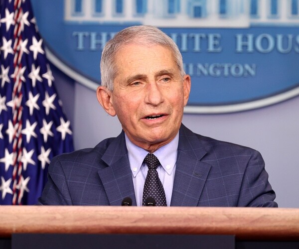 anthony fauci speaks into microphone