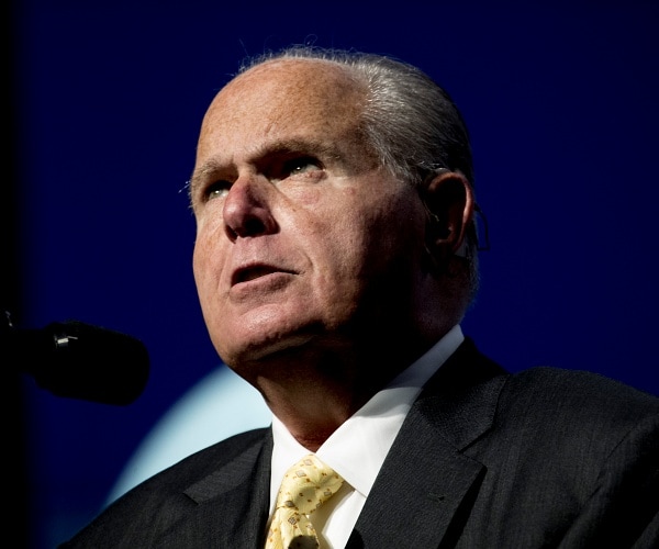 rush limbaugh speaks into microphone