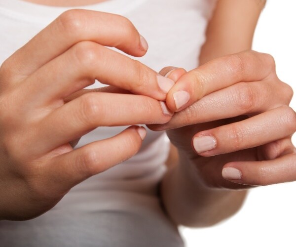 woman picking at nails