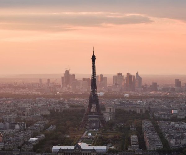 the eiffel tower is pictured at sunset
