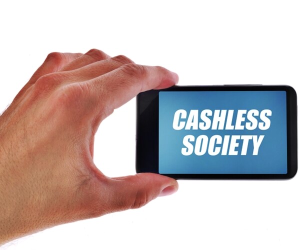 businessman holding smartphone with cashless society title