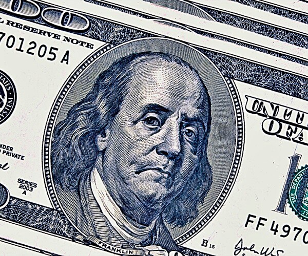 depressed ben franklin frowning on face of 100 bill