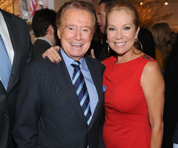 regis, in blue suit, dress shirt and tie is seen with kathie lee in a red dress