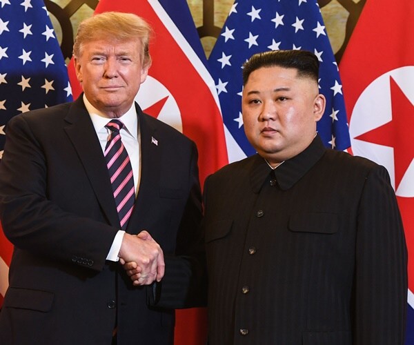 president donald trump and chairman kim jong un shake hands