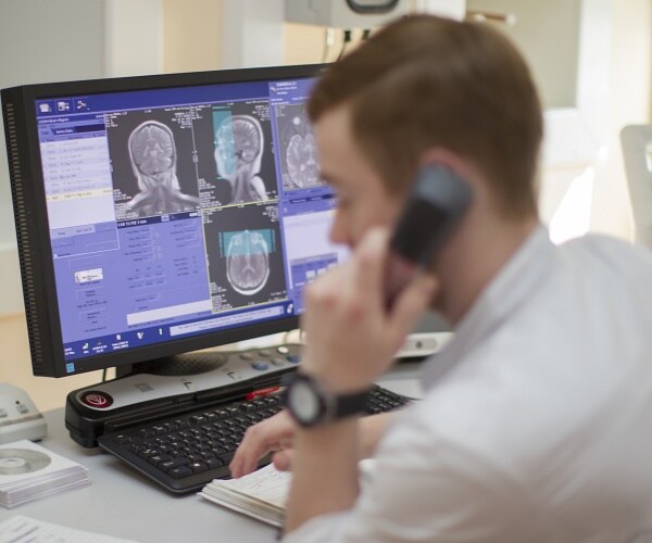 doctor looks at brain mri