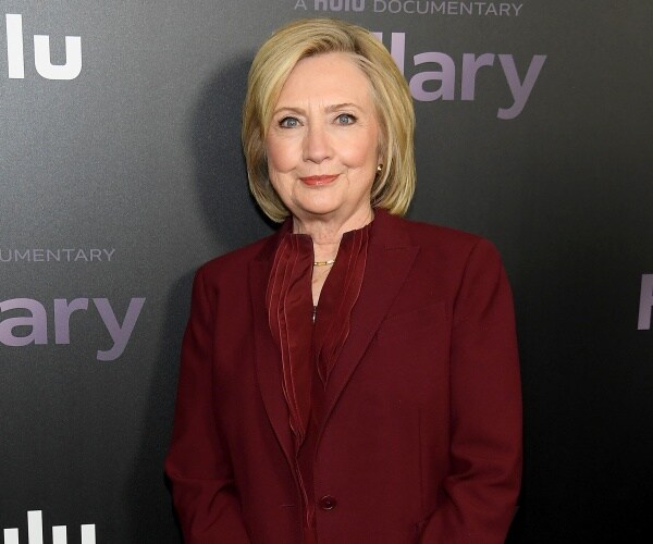 hillary clinton poses for photo