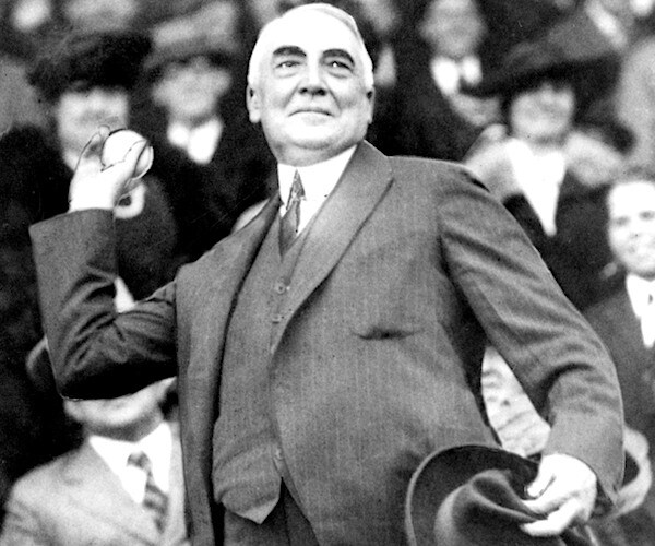 President Warren G. Harding throws out the first ball to open the Washington Senators' baseball season in 1921