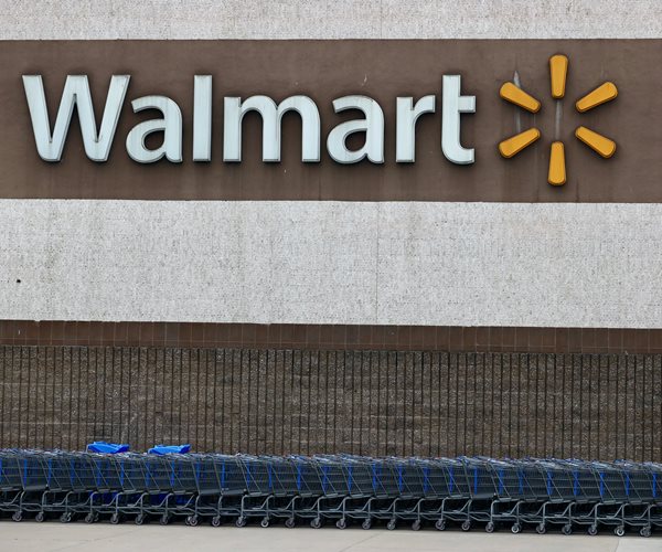 walmart sign set against the brown background of a retail store