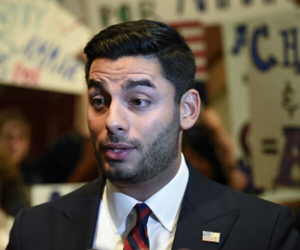 democrat ammar campa-najjar in a black suit, white dress shirt, blue and red neck tie 