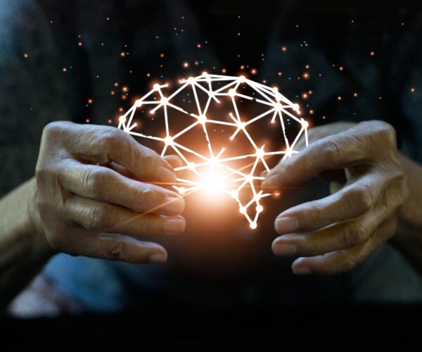 hands holding a brain image