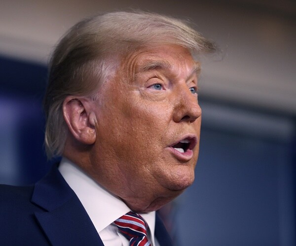 donald trump stands behind podium