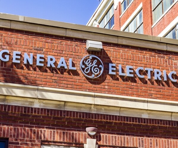 general electric ge company logo symbol in silver on red brick background