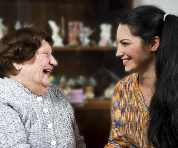 older woman, younger woman talking and smiling