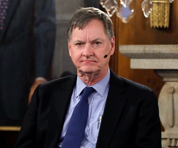 charles evans speaks into wireless mic