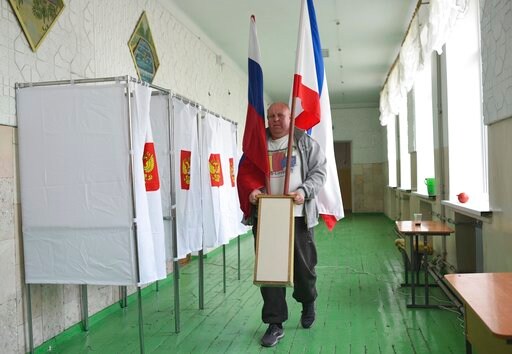 The Latest: Russian Election Monitor Fears Vote Day Pressure