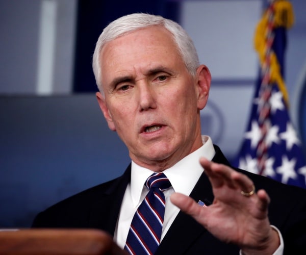 pence in a black suit and navy blue striped tie speaking in the press briefing room