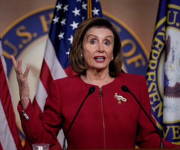 nancy pelosi speaks into mic