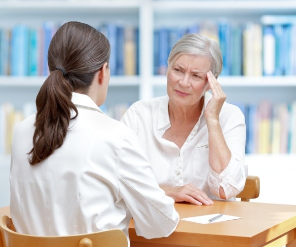 older woman talking to doctor about her symptoms