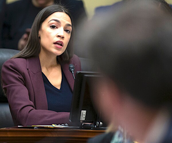 alexandria ocasio-cortez sits on a house committee questioning a guest