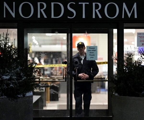an officer stands inside a mall