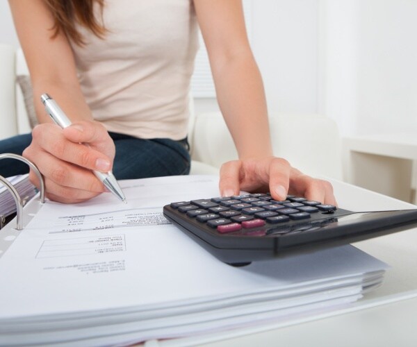 woman calculating personal finances with a calculator