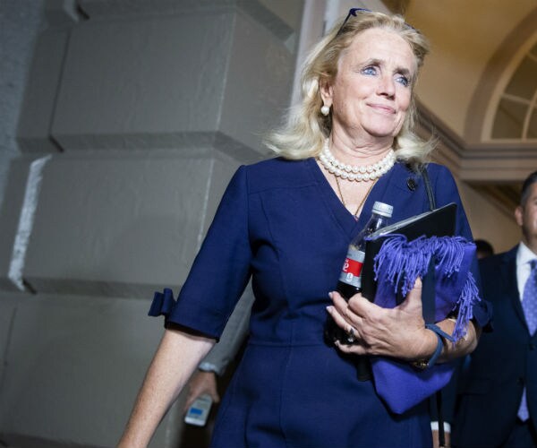 debbie dingell walks out of the capitol hill after a house vote