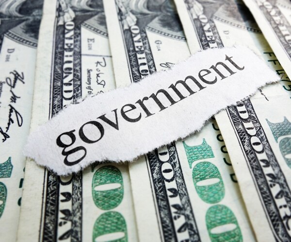 government newspaper scrap on assorted one hundred dollar bills