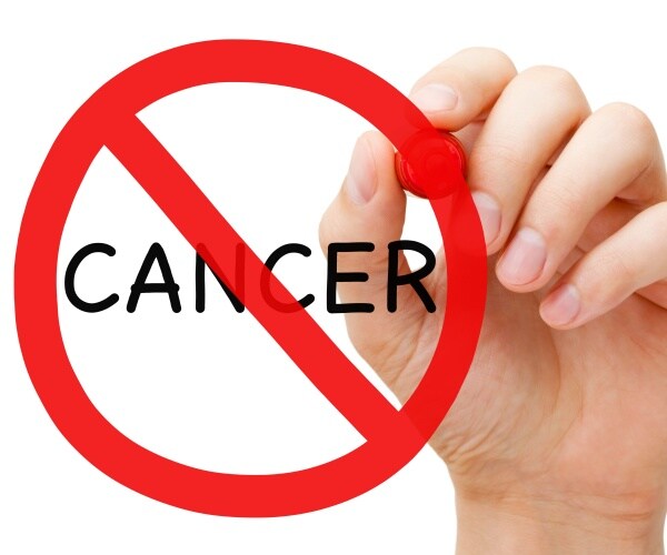 hand drawing  a red circle with line through it around the word 'cancer'