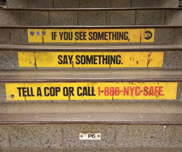 stairs at new york city subway station with words if you see something say something