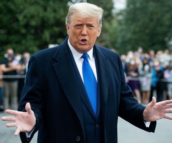 donald trumps walks across driveway