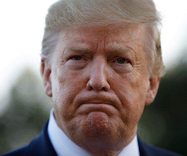president donald trump grimaces during a news conference with the media