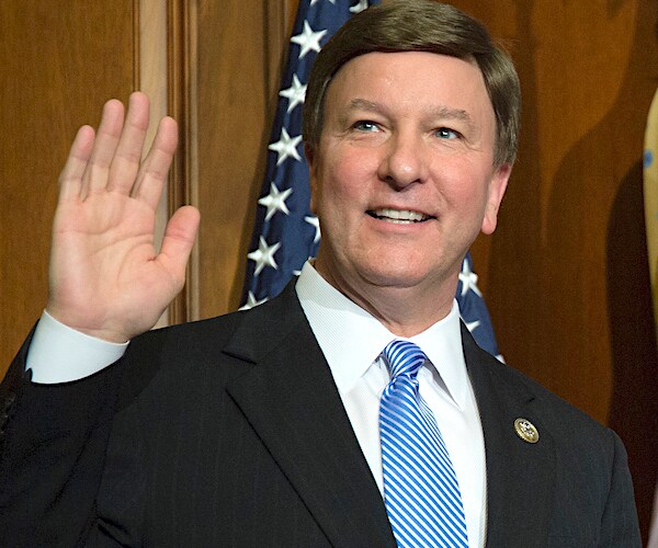 alabama's mike rogers holds his right hand up as he is sworn in