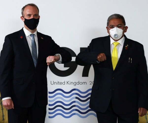 Britain's Foreign Secretary Dominic Raab standing with Brunei Second Minister of Foreign affairs Erywan Yusof