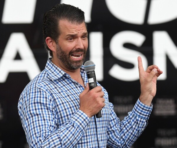 donald trump jr stands onstage