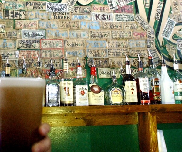 money on the walls of a bar