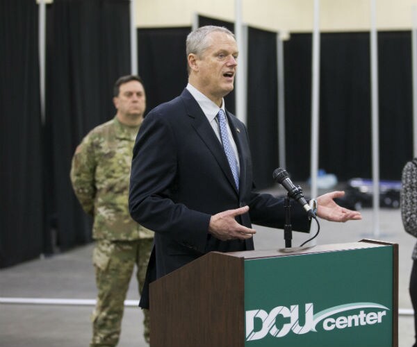 massachusetts gov. charlie baker is shown speaking at a podium