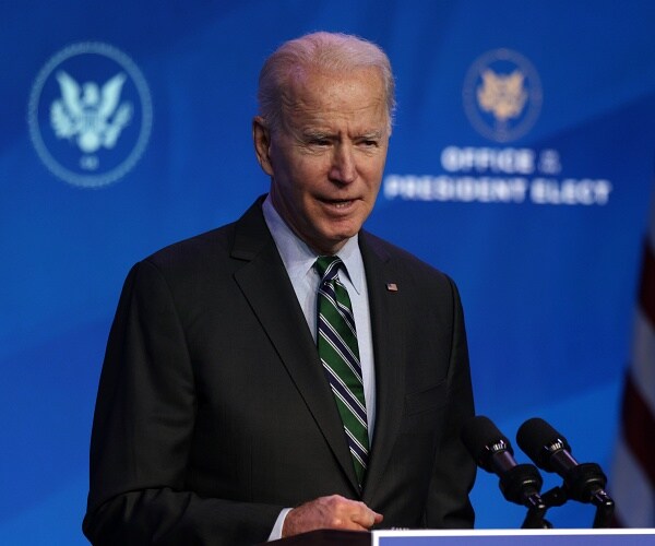 joe biden speaks into microphone