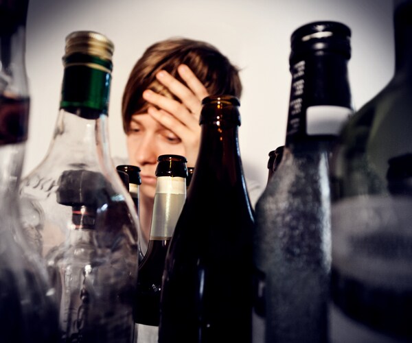 a woman in front of empty bottles