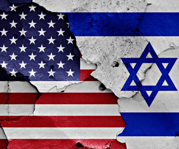 united states and israeli flags on a wall with cracks in them