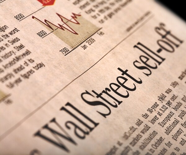 Financial newspaper page with headline Wall Street sell-off - perspective view with shallow depth of field. 