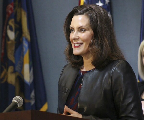 michigan gov. gretchen whitmer is shown speaking at a podium