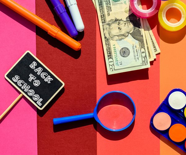 school supplies, money and back-to-school sign