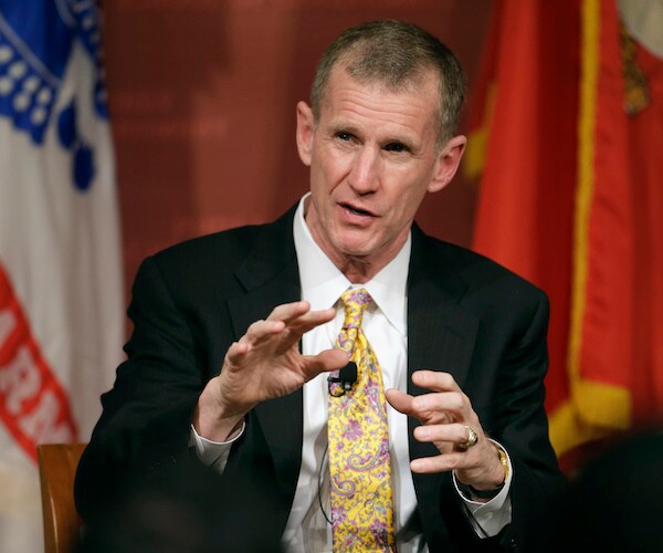 Stanley McChrystal gestures as he speaks during a conference