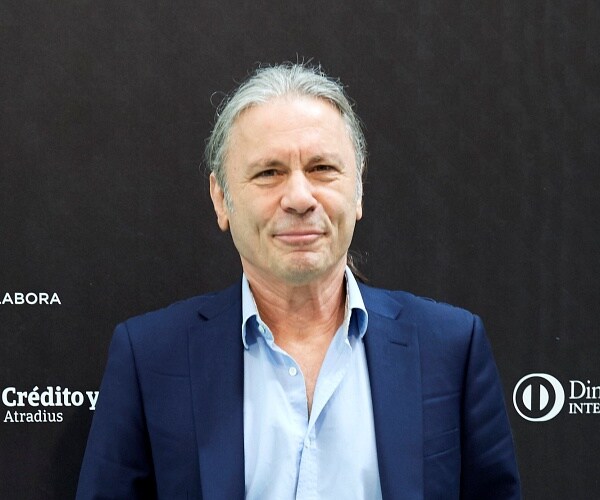 bruce dickinson stands on red carpet