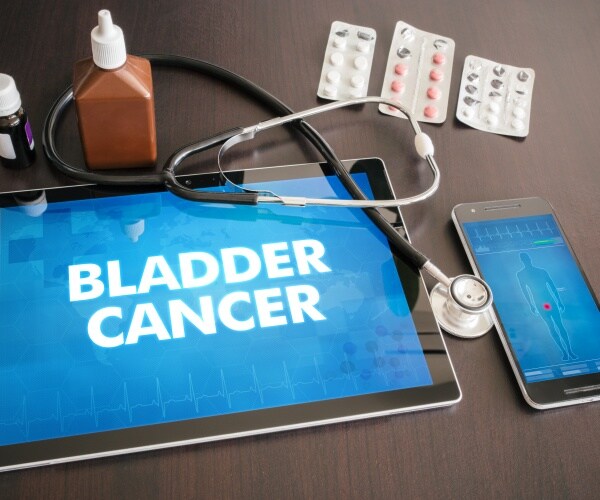 tablet that says 'bladder cancer' with stethoscope, medication around it